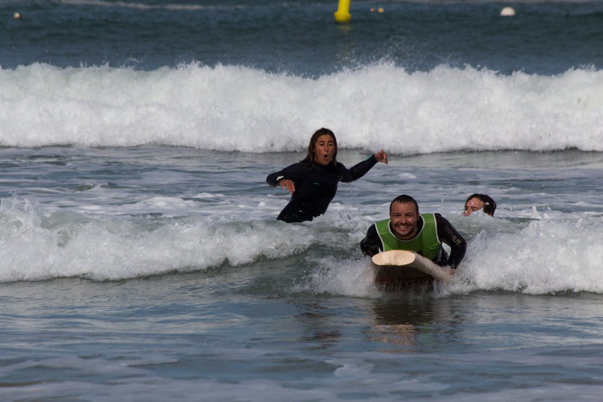 Inclusive surfing practice in Brittany, encouraging local participation in low-impact maritime leisure activities and promoting access to the sea for people of all abilities.