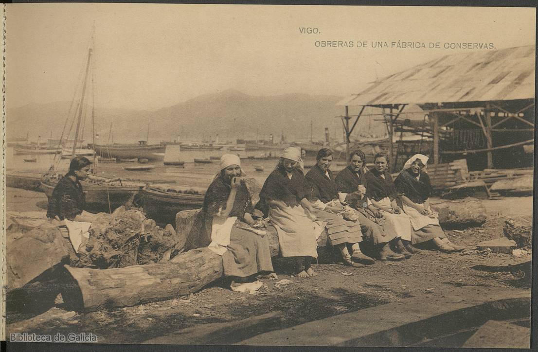 Workers from the Vigo canning factories during a rare moment of rest, while the busy harbour behind them brims with boats, reflecting the city’s bustling industrial and maritime activity.