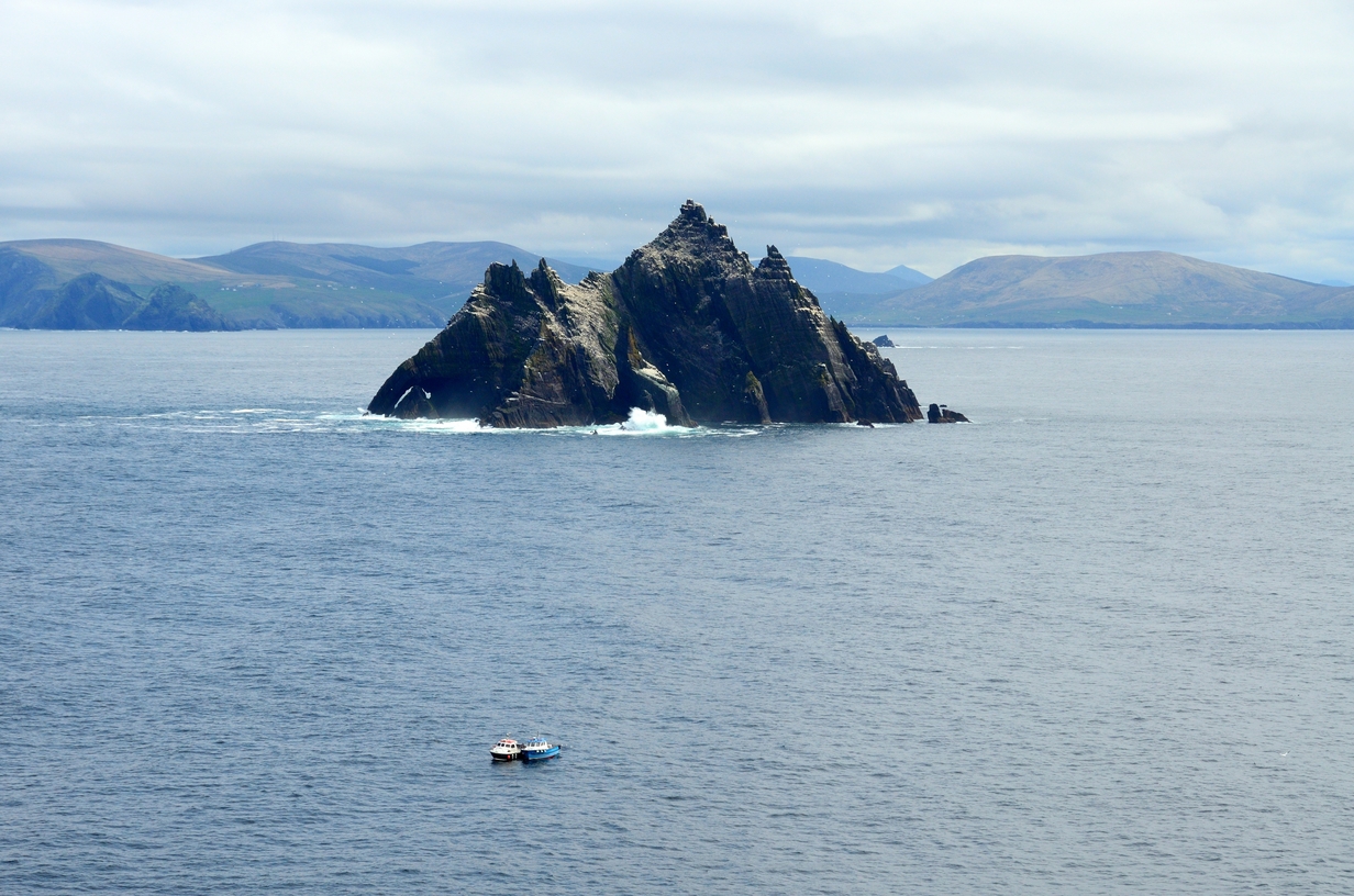 The island's dramatic rocky mass emerges from the Atlantic Ocean, with the mountains of the Iveragh Peninsula visible in the background. Renowned for its seabird colonies, Little Skellig is an iconic feature of Ireland's Atlantic seascape. 