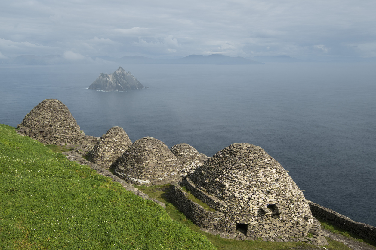 Early medieval monastic complex composed of dry-stone beehive huts and terraced enclosures adapted to steep Atlantic slopes.