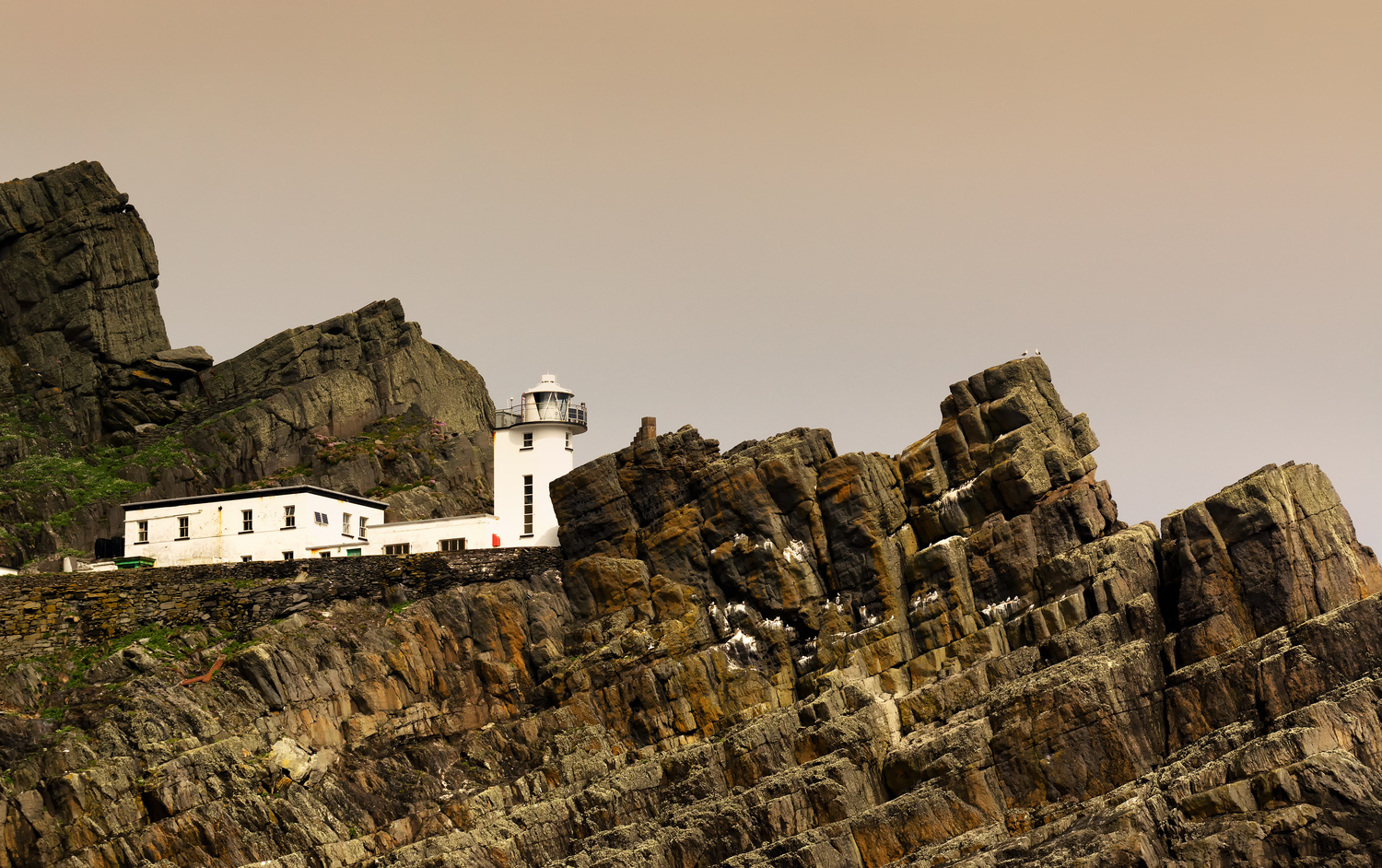 Engineered structures embedded in steep rock, illustrating technical responses to hazardous Atlantic coastal conditions.