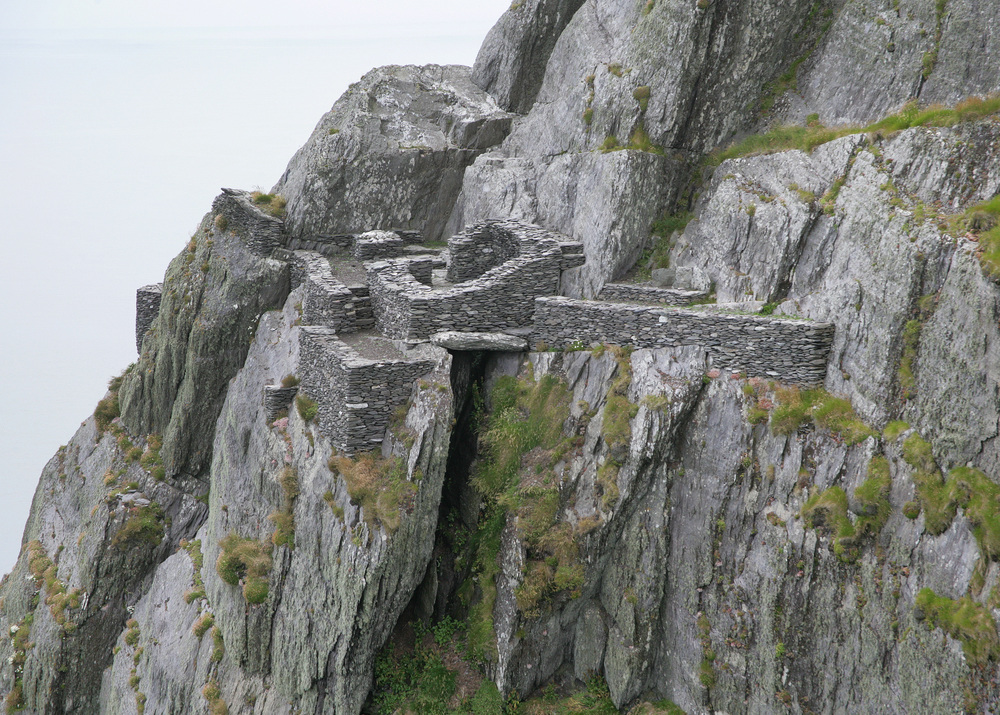 Remote hermitage arranged in terraces below the South Peak, accessible only through steep and hazardous rock-cut pathways.