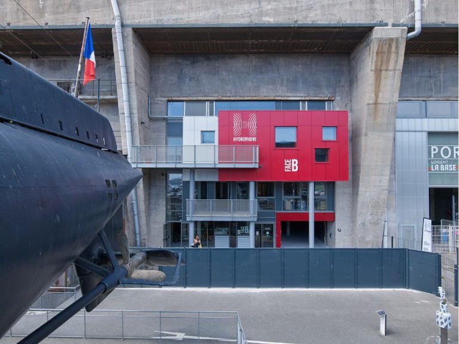 One of the former submarine pens adapted to host a company linked to the offshore sailing industry, where high-performance technological research and development coexists with the exhibition of a French submarine.